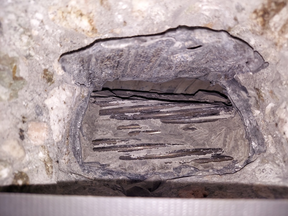 Chipped out section of concrete showing the post-tensioning cables of the bridge structure