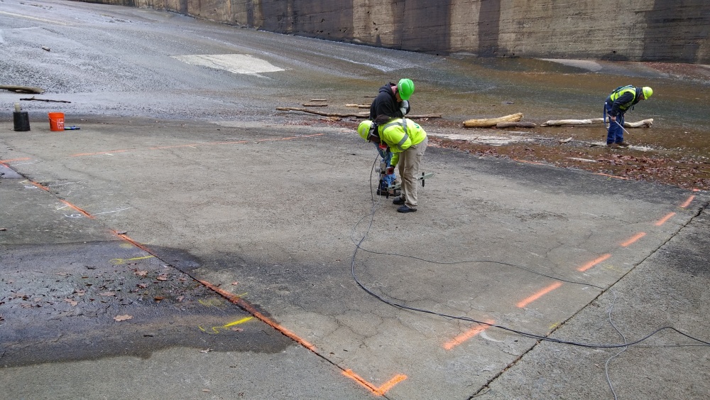 Crew in PPE collecting IE/PV data within a typical spillway test area.