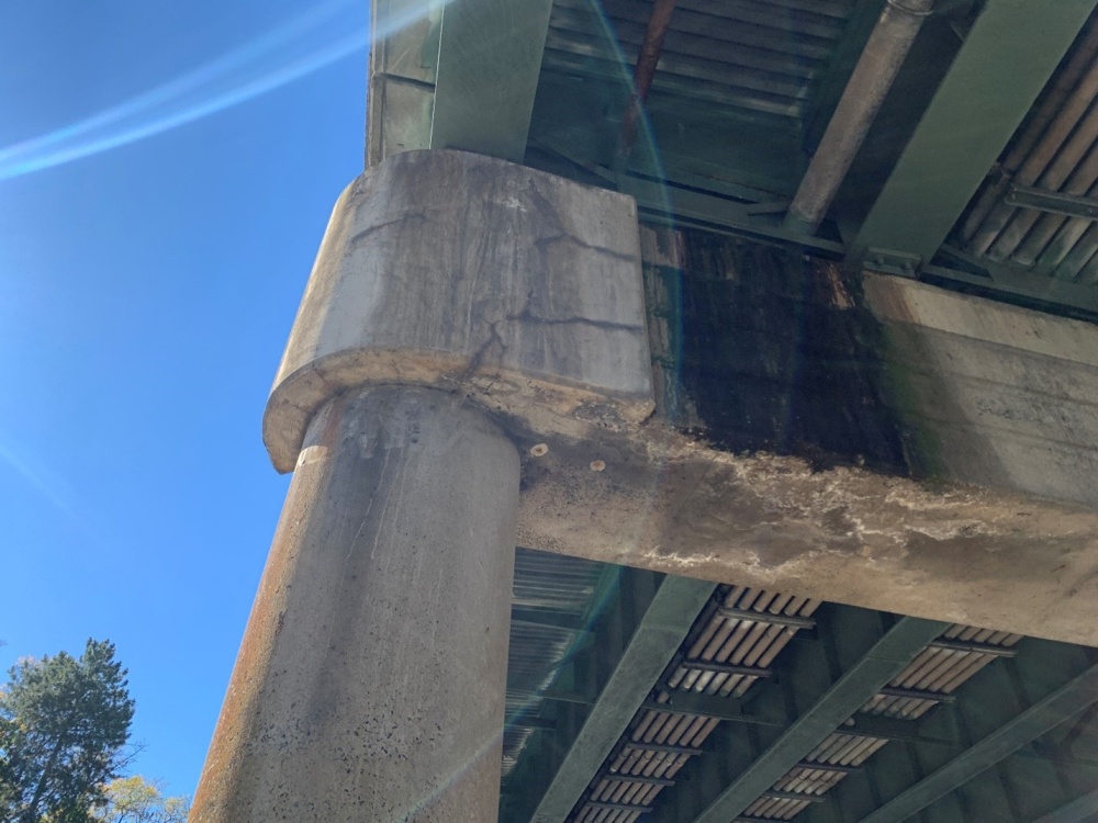 Severely Corroded concrete Pier Cap showing exposed steel rebar